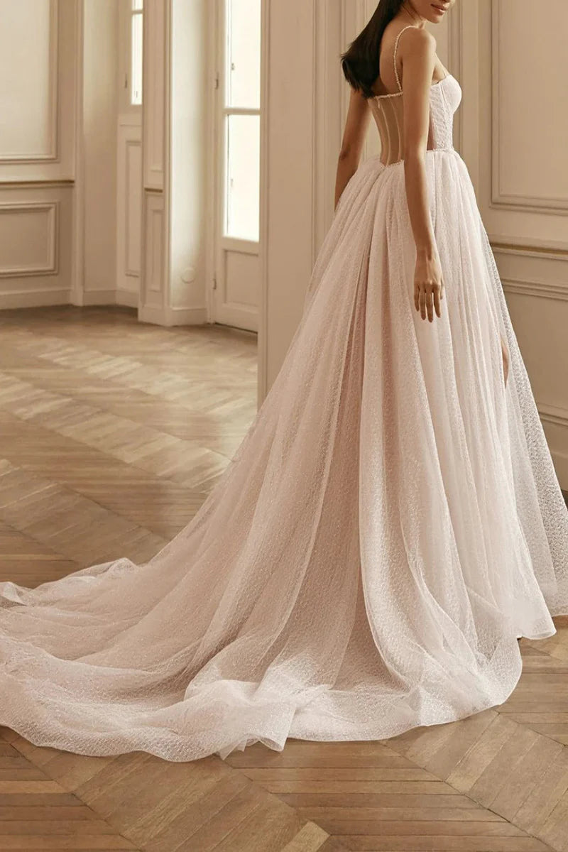 A-Line bridal gown featuring a thigh split and intricate appliques.
