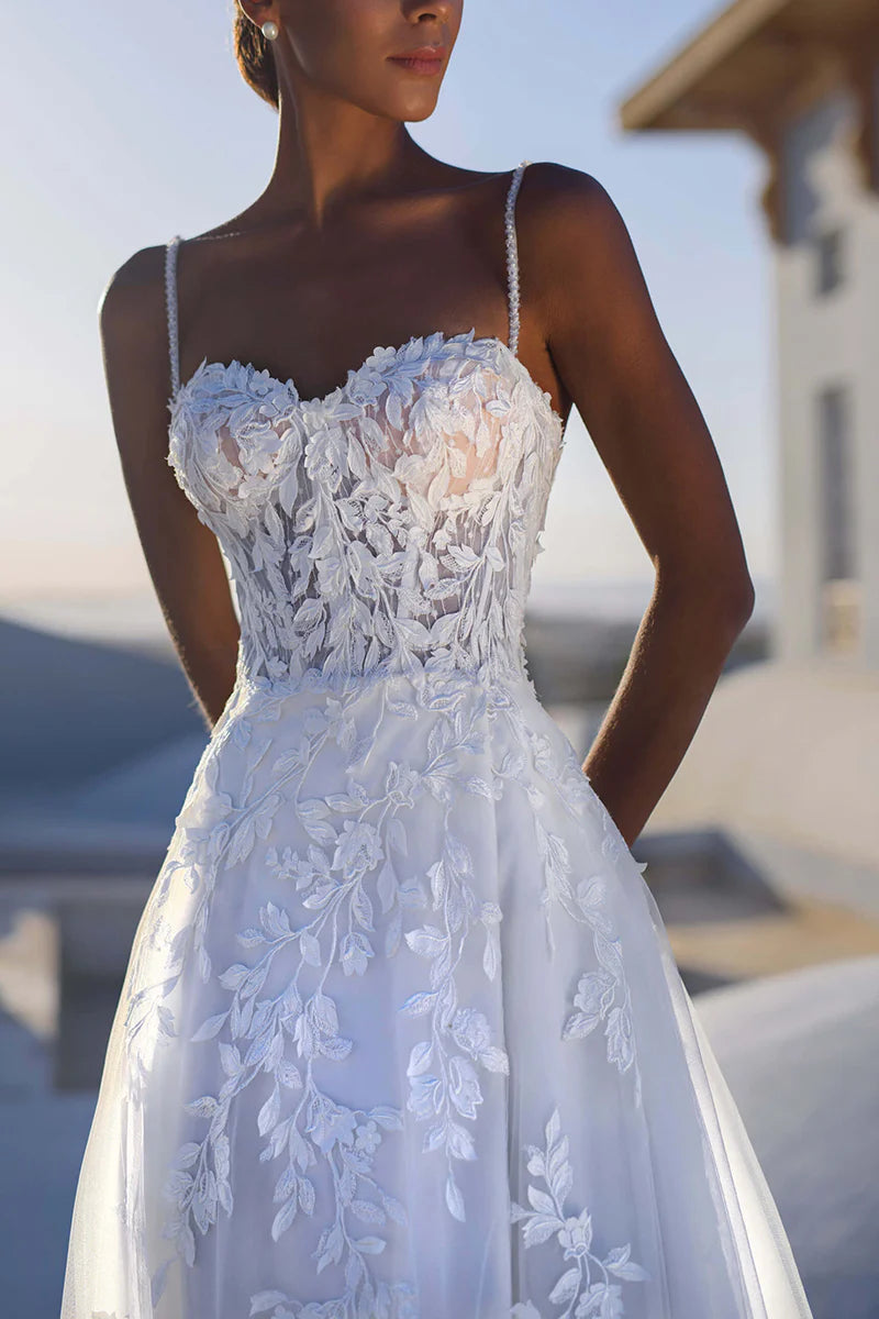 Back view of the A-line wedding dress showing spaghetti straps and ankle length.