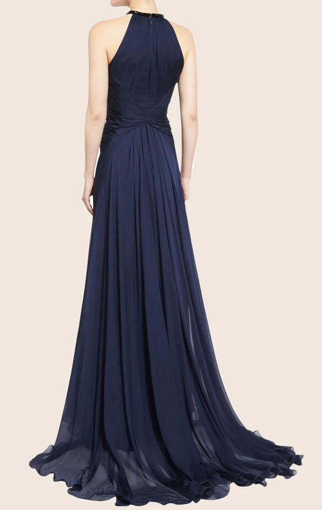 Woman wearing an elegant dark Bardot neck chiffon evening gown.