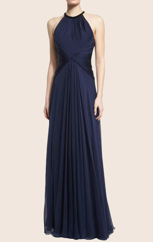 Side view of a woman in a dark ankle-length formal chiffon dress.