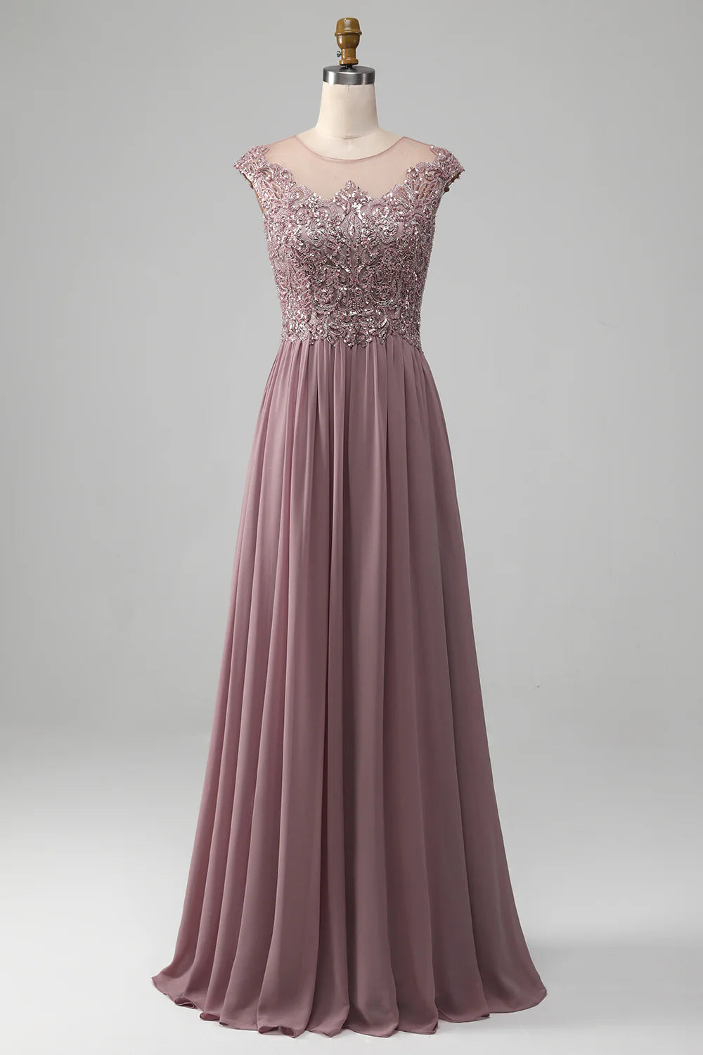 Woman wearing an elegant A-line beaded chiffon round neck maxi dress.