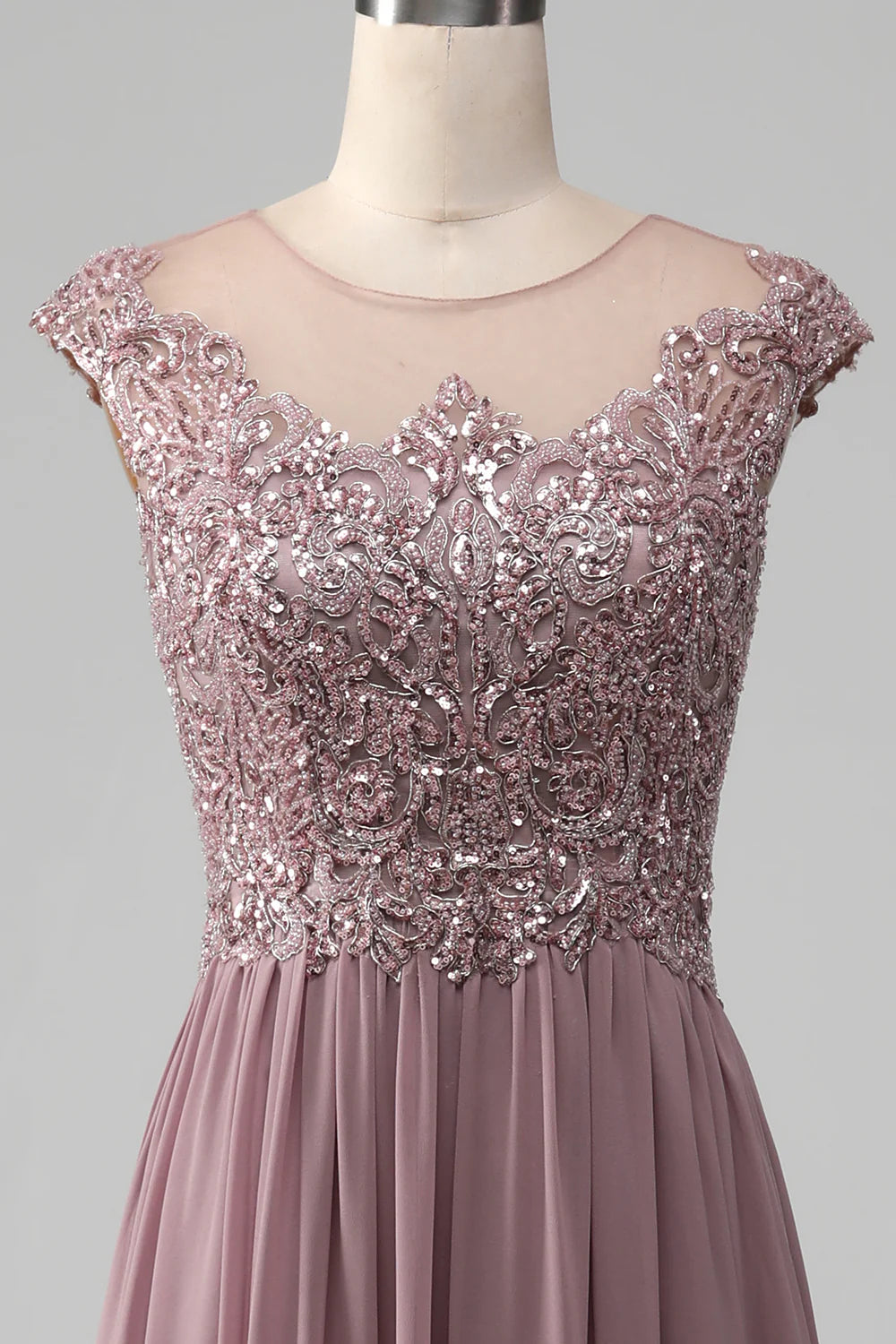 Detail of the round neckline and bodice of the beaded maxi dress.