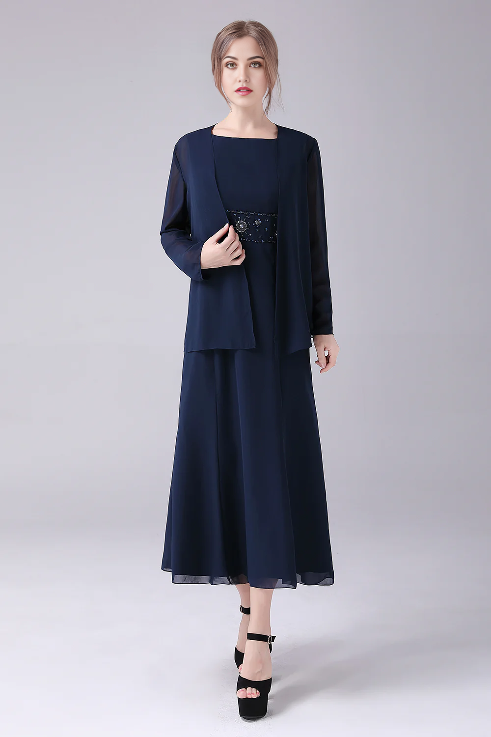 Woman in elegant A-line two-piece Mother of the Bride dress.