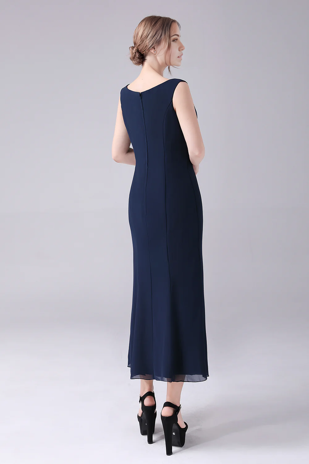 Close-up of the boat neck and long sleeves on the formal gown.