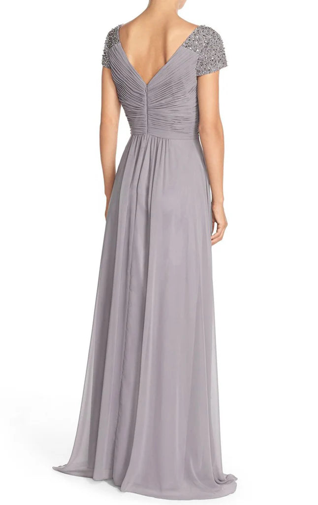 A woman in a formal A-line chiffon dress, highlighting the elegant silhouette and fabric.
