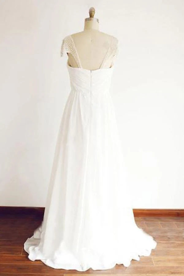 Flowing A-line beach wedding gown with delicate beading and cap sleeves.