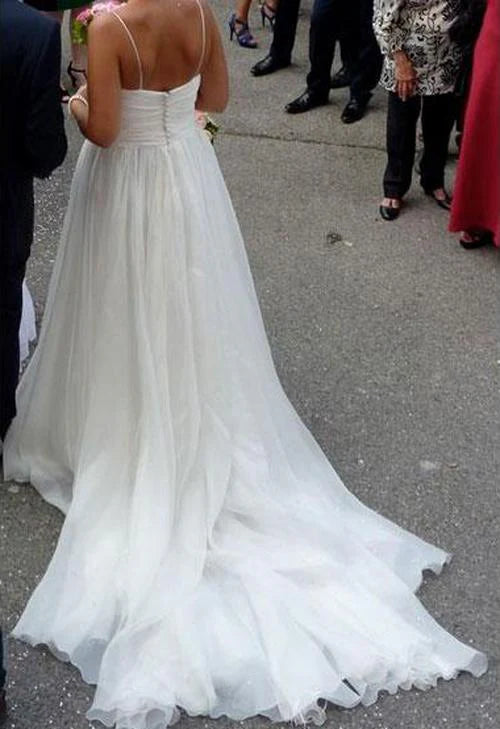 Back view of a flowing A-line chiffon wedding gown with court train.