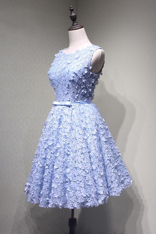 Side view of the A-line blue lace dress, highlighting the knee length and appliques.