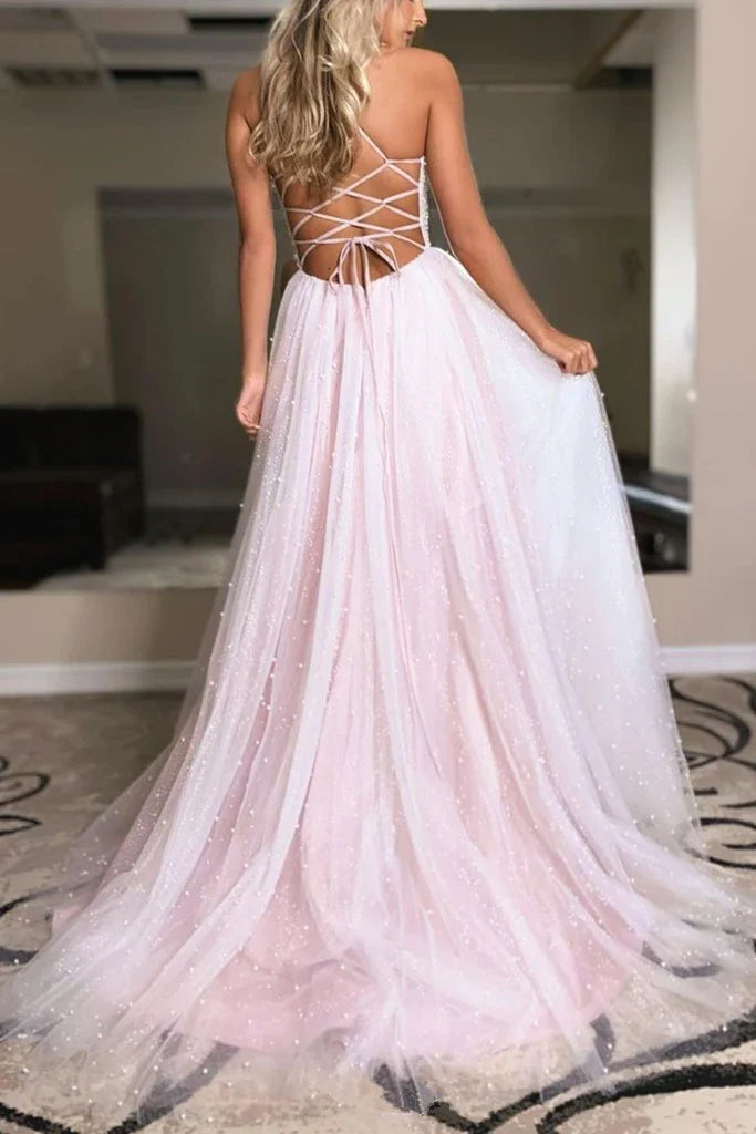 Close-up of the backless design and intricate beading on the long prom dress.