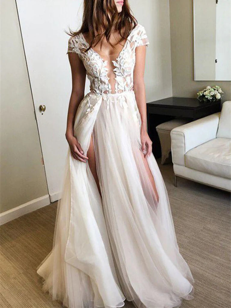 Model wearing an A-line deep V-neck lace long dress with cap sleeves and a front slit.