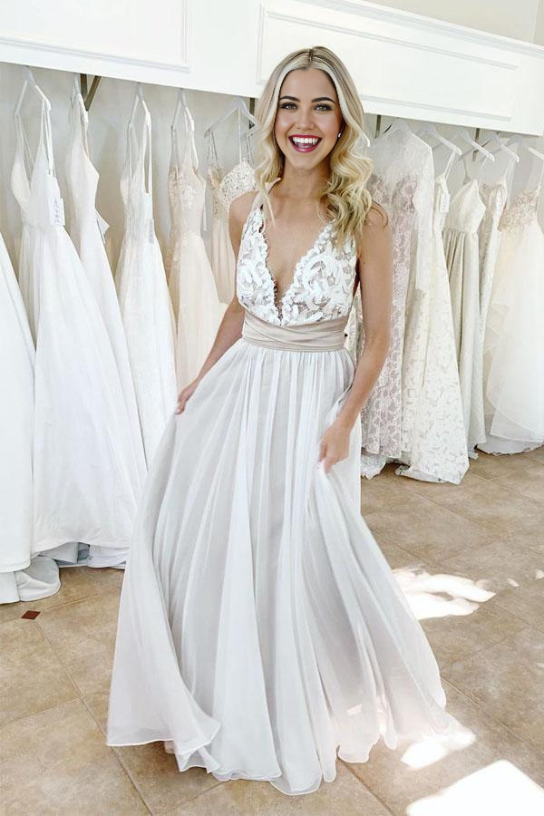 Elegant A-line deep V-neck wedding dress with a criss-cross back and waistband.