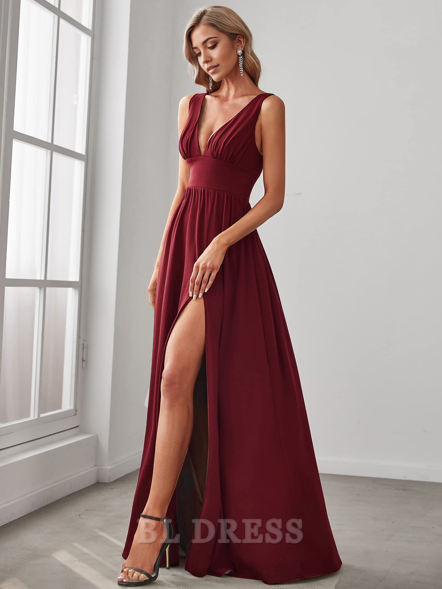 Floor-length A-line dress with deep V-neck and side slit.