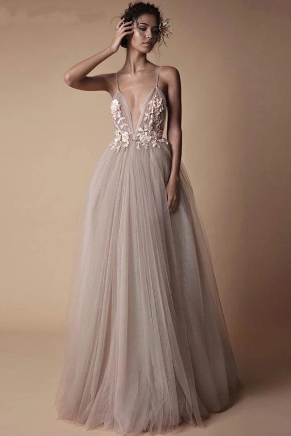 Full view of an A-line deep V-neck spaghetti strap beach wedding dress with applique.