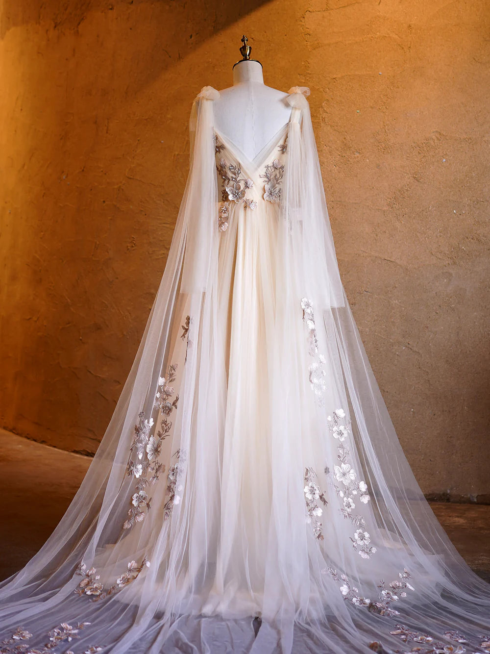 Side view of an A-line floor-length tulle gown.