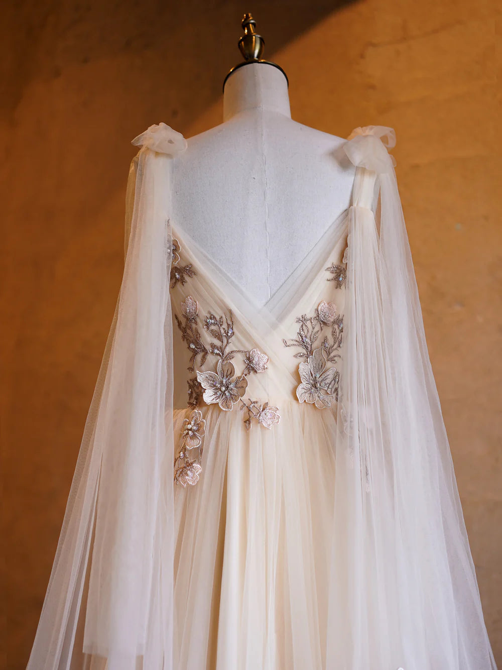 Back view of a deep V-neck tulle prom dress.