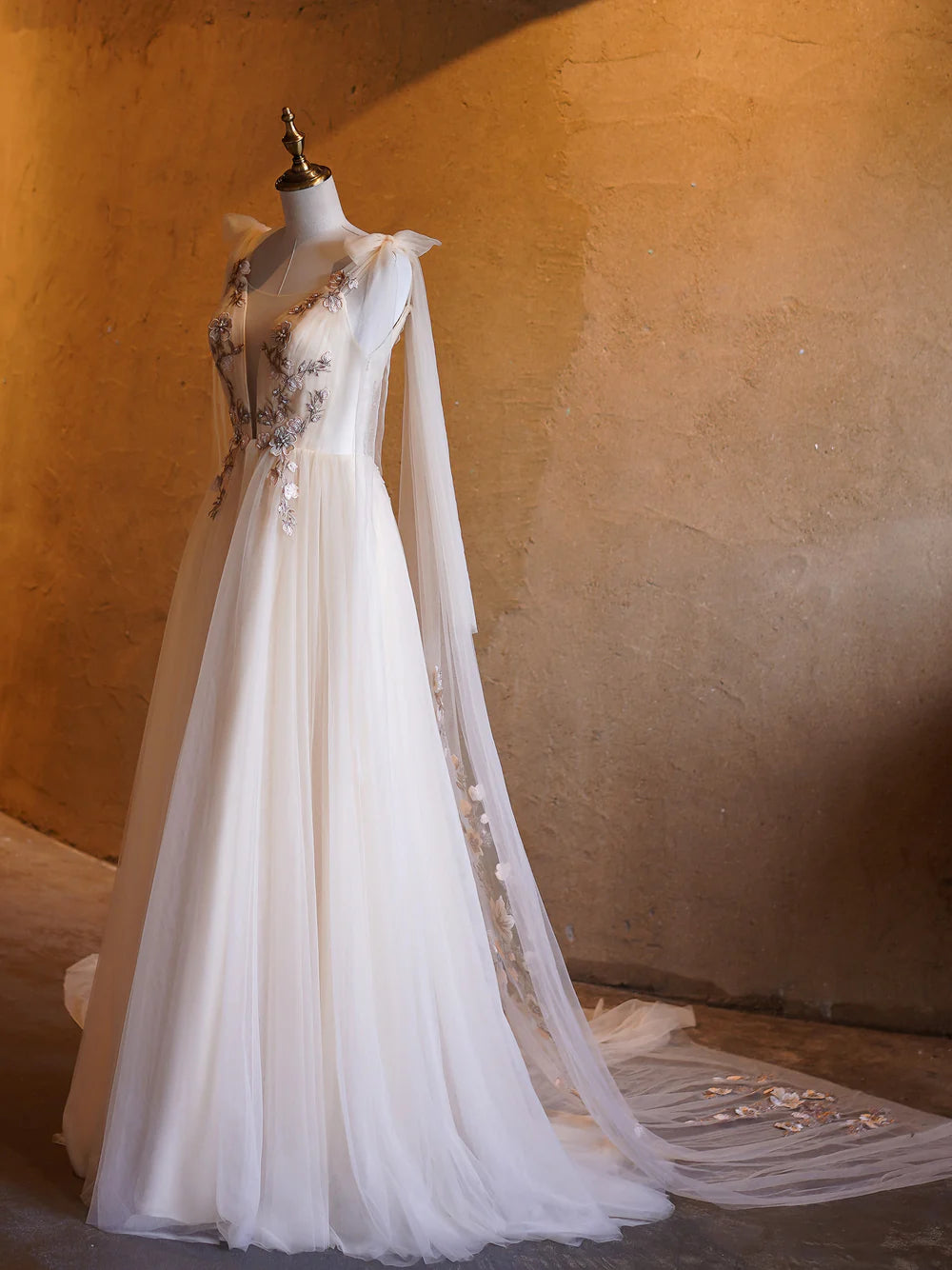 Model walking gracefully in a flowy A-line tulle dress.