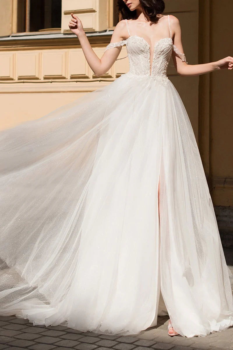 Elegant A-line deep V-neck wedding gown with beaded details and a side slit.