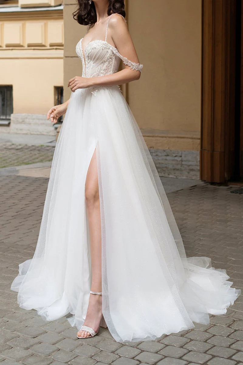 Close-up of the beaded embellishments on the deep V-neck wedding dress.