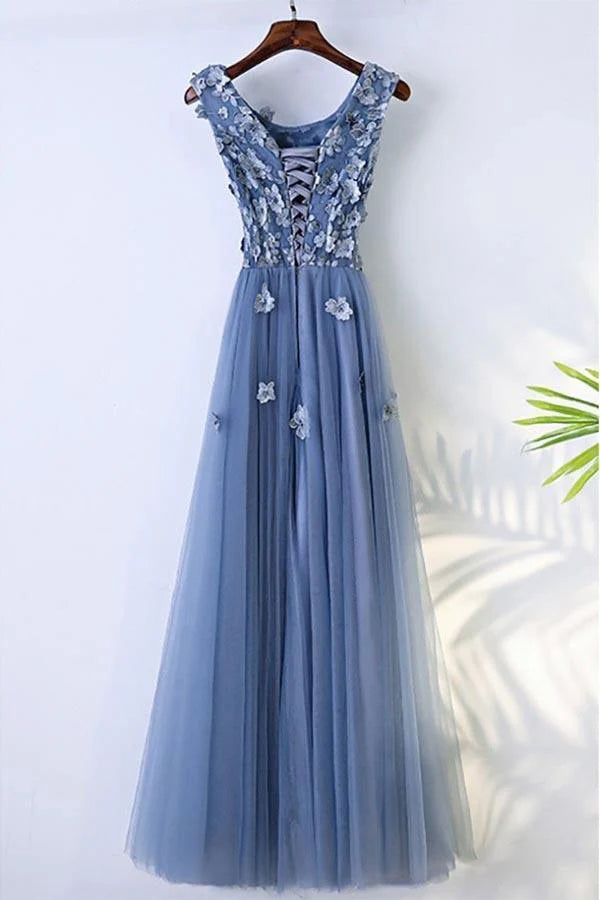 Woman wearing an A-line floral prom maxi dress, side view.