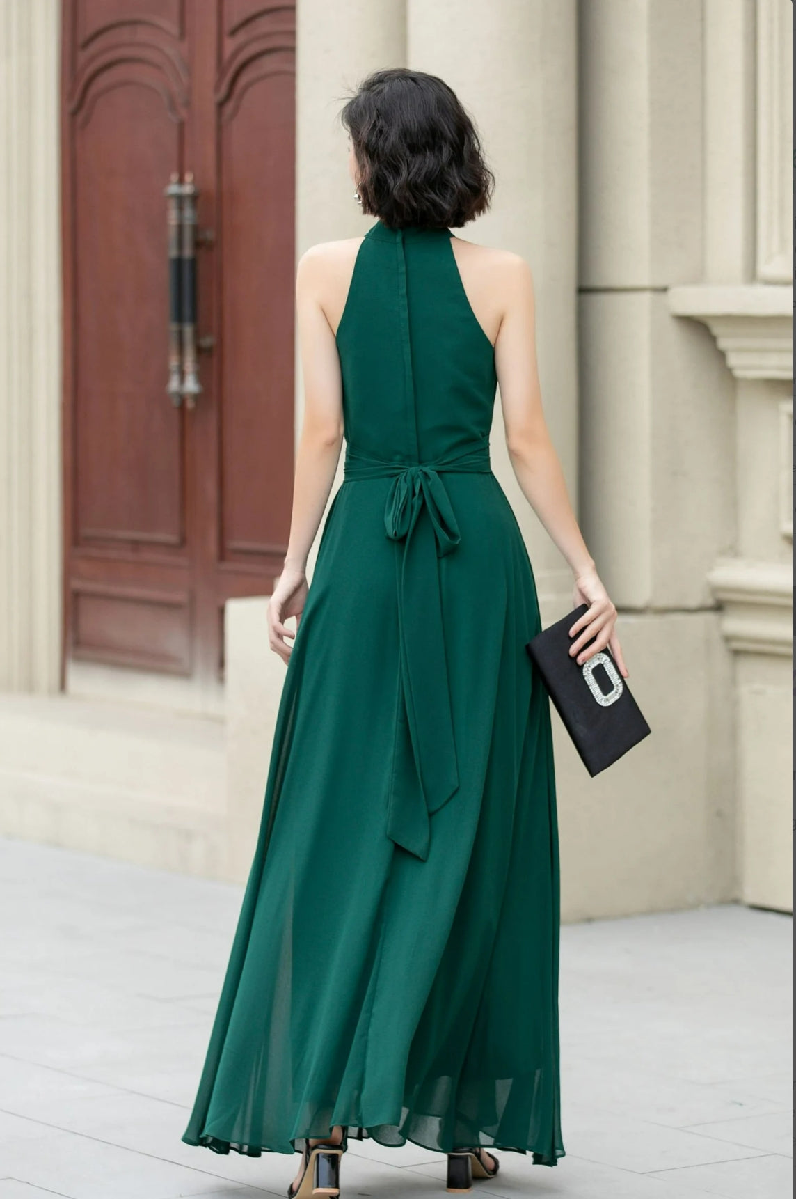 Back view of the A-line halter chiffon dress on a model.