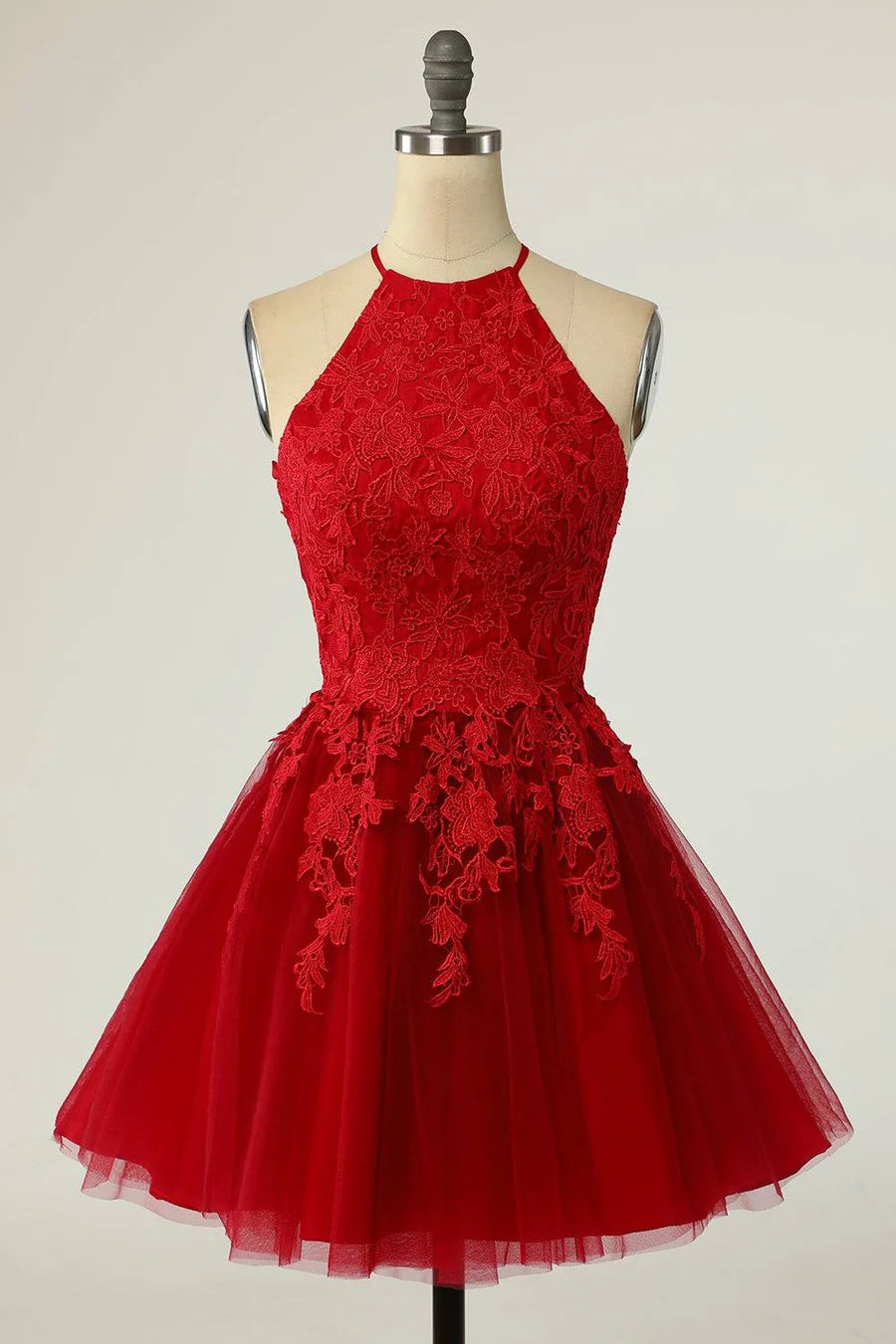 Elegant A-line halter homecoming dress with keyhole back and applique details.
