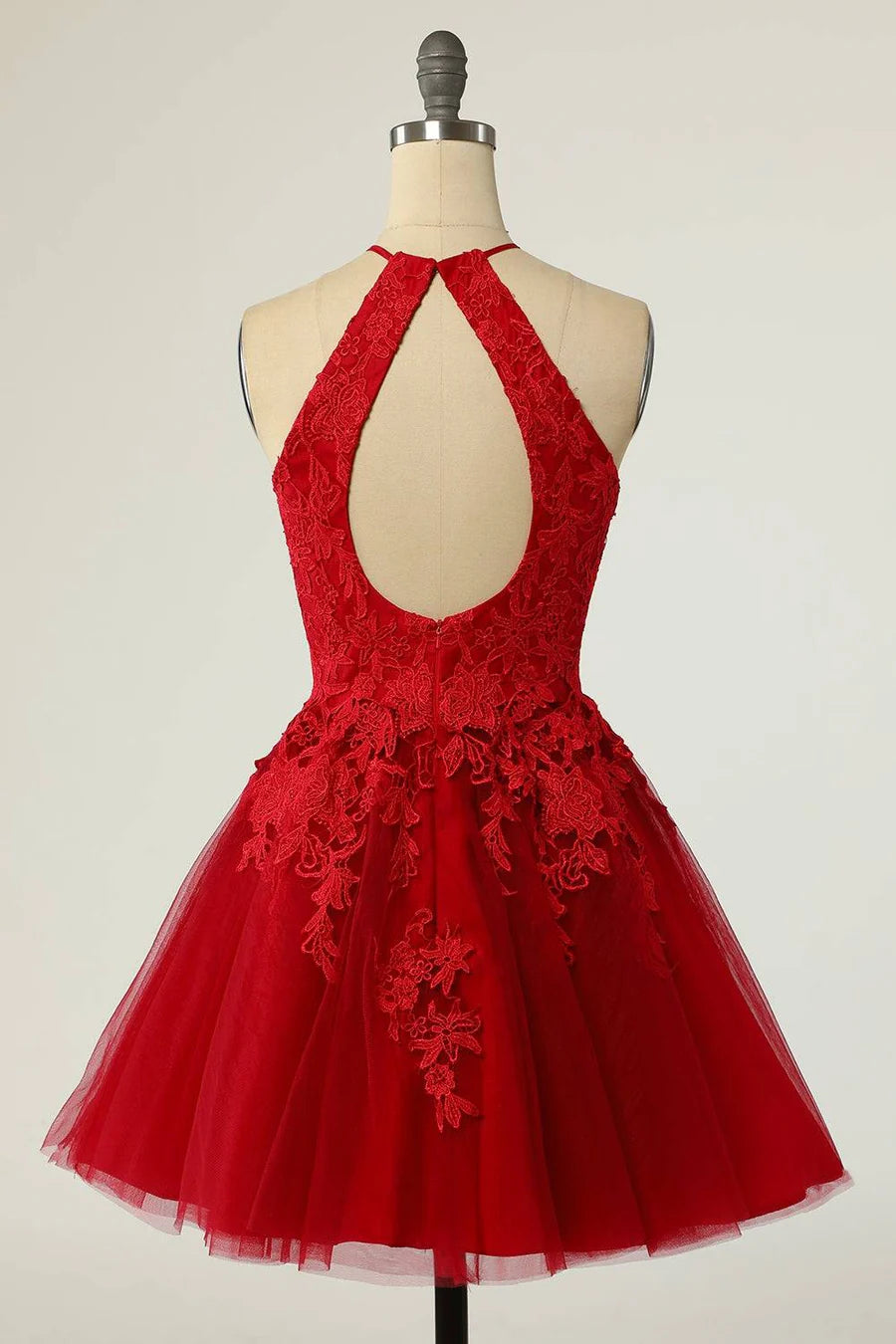 Side view of A-line halter dress showcasing applique embellishments.