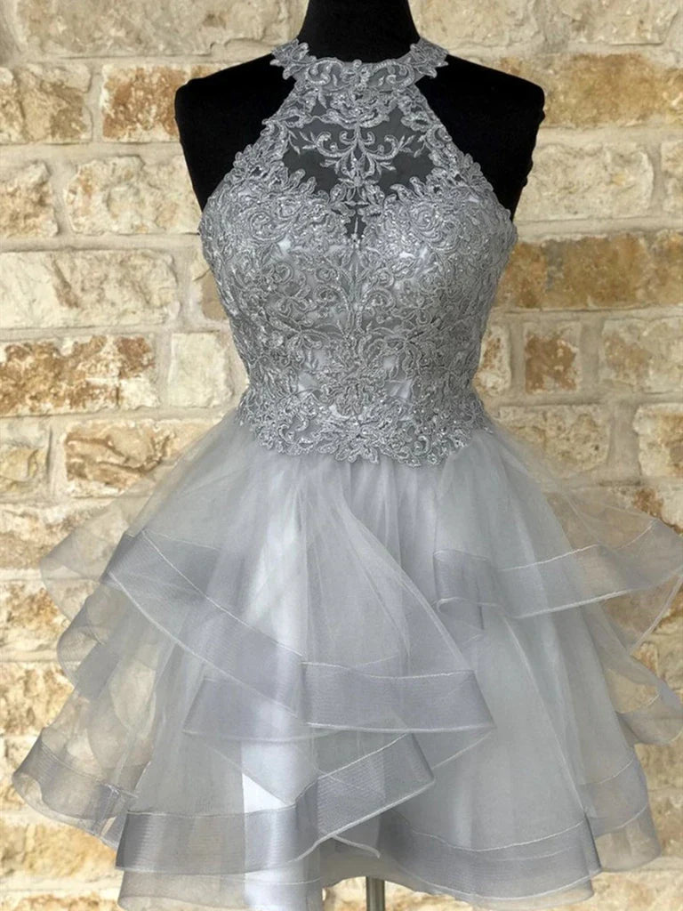 Model wearing an elegant A-line halter neck lace short homecoming dress.