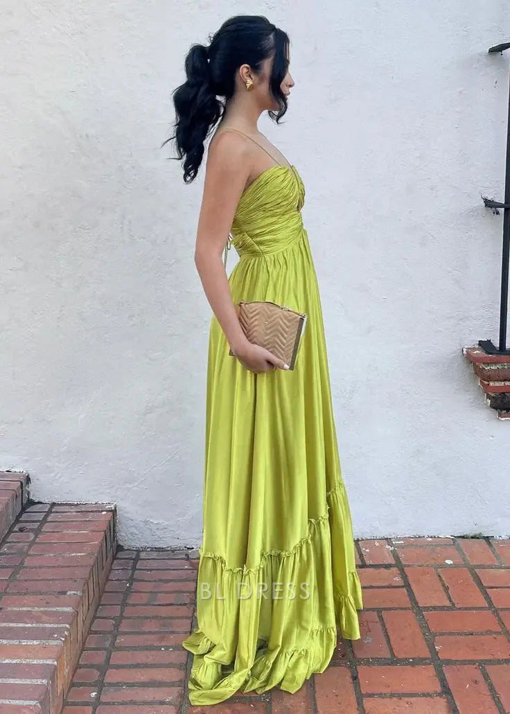 Back view of a model in a green A-line halter satin ruched dress.