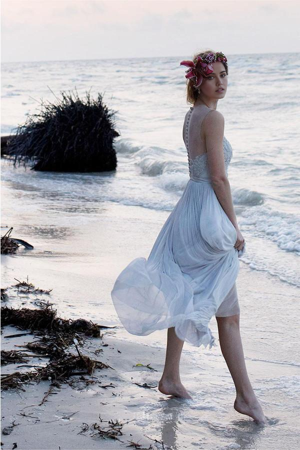 Elegant chiffon wedding gown with lace details for a beach ceremony.