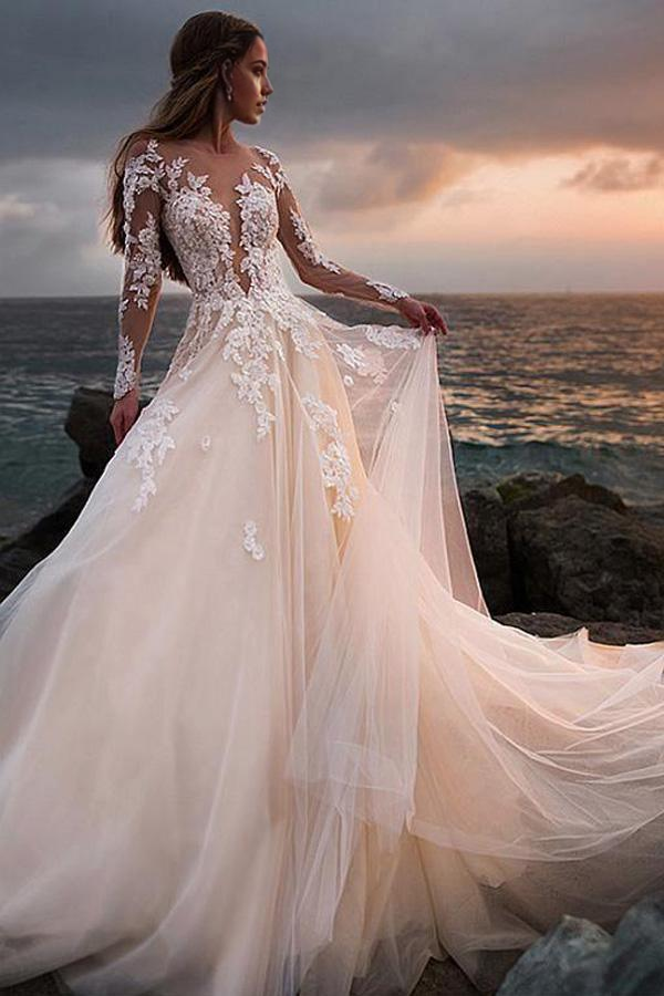 Side profile of the graceful ivory tulle wedding gown, ideal for a romantic beach ceremony.