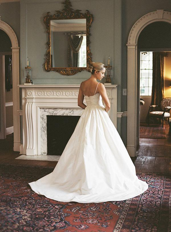 Back view of a flowing A-line lace wedding gown.