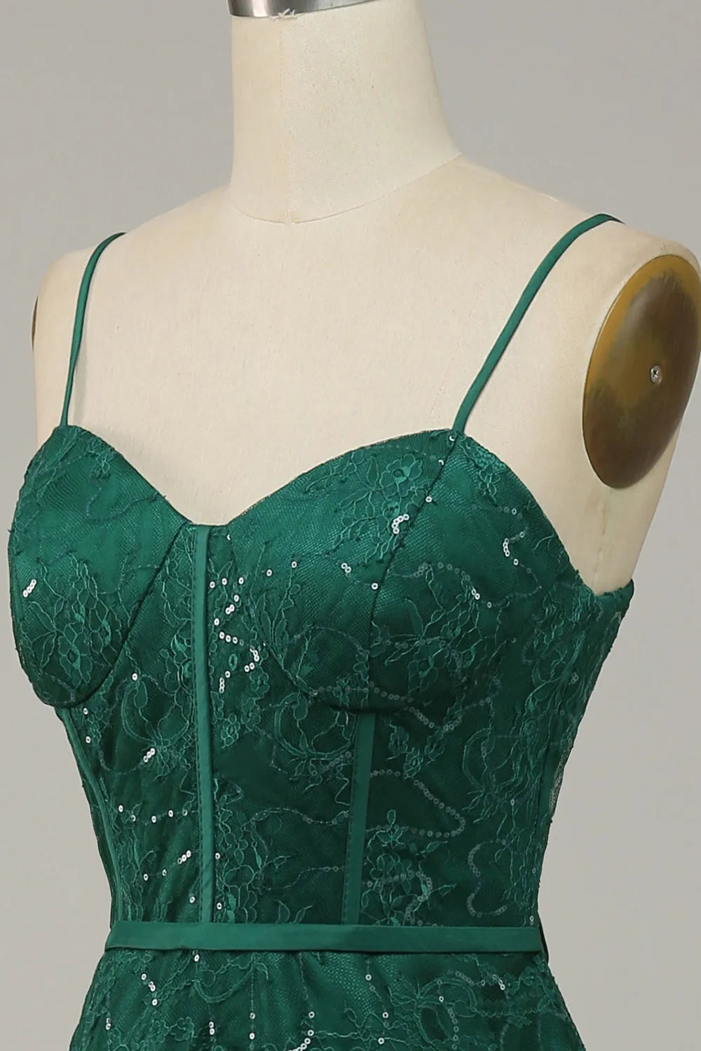 Side profile of the model in the graceful lace spaghetti strap prom dress.