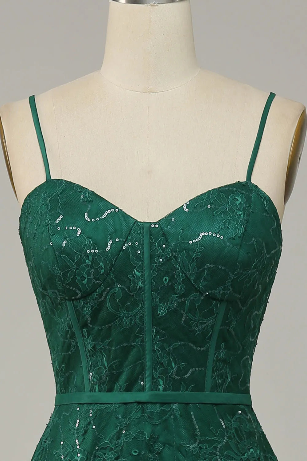 Detail of the V-neckline and slender spaghetti straps of the lace prom dress.