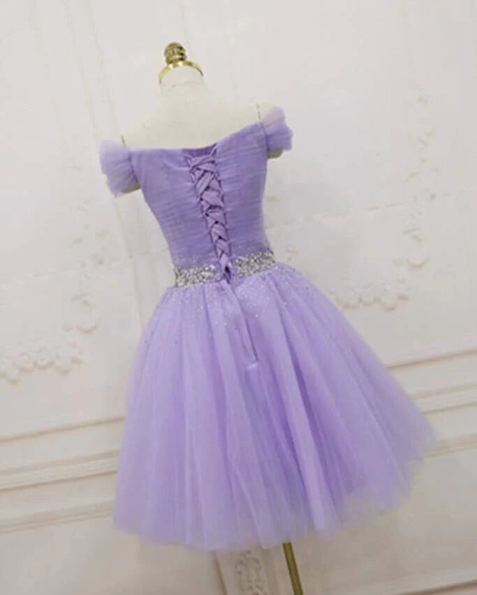 Model wearing a short purple off-shoulder homecoming dress.