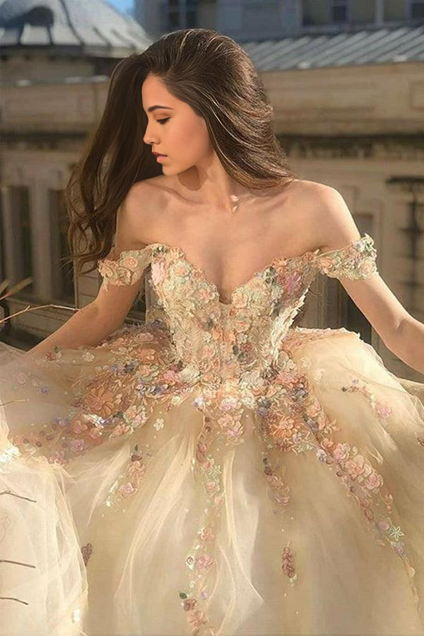 Woman wearing an elegant A-line off-shoulder champagne lace floral prom dress.