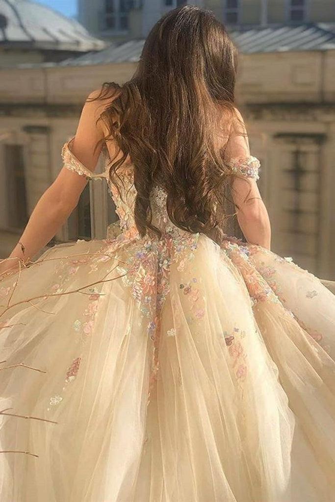 Close-up of champagne lace floral detail on off-shoulder dress.