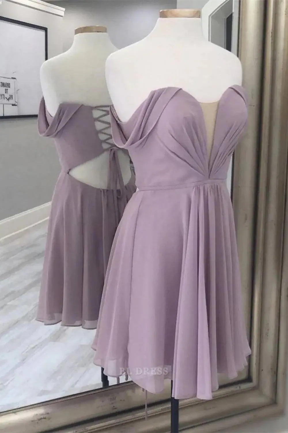 Woman wearing a periwinkle A-line off-shoulder chiffon dress with a corset back.