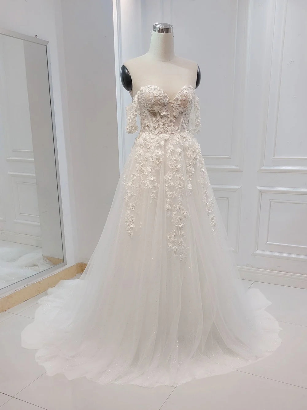 White A-line wedding dress with delicate floral embroidery.