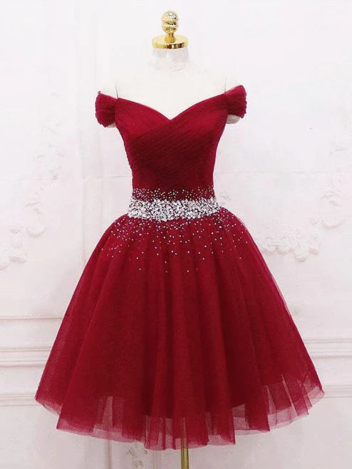 Woman wearing an elegant A-line off-shoulder short prom dress.