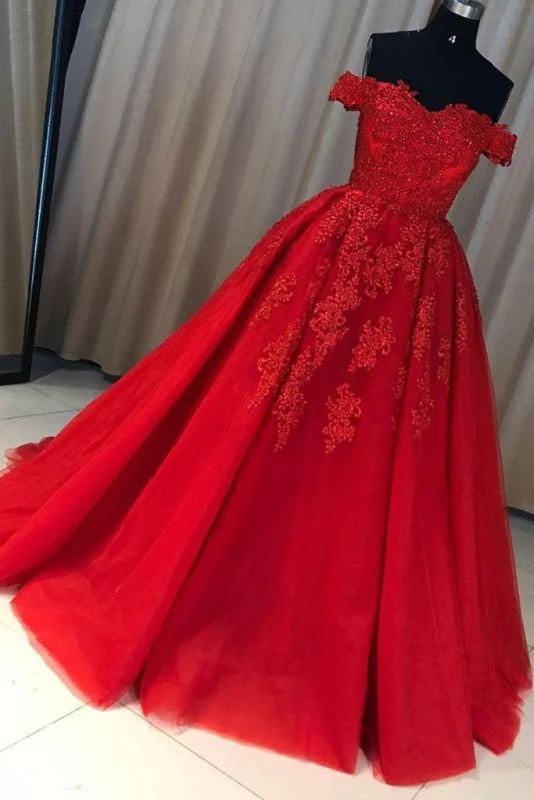 Elegant A-line off-shoulder evening gown with lace appliques and long tulle skirt.