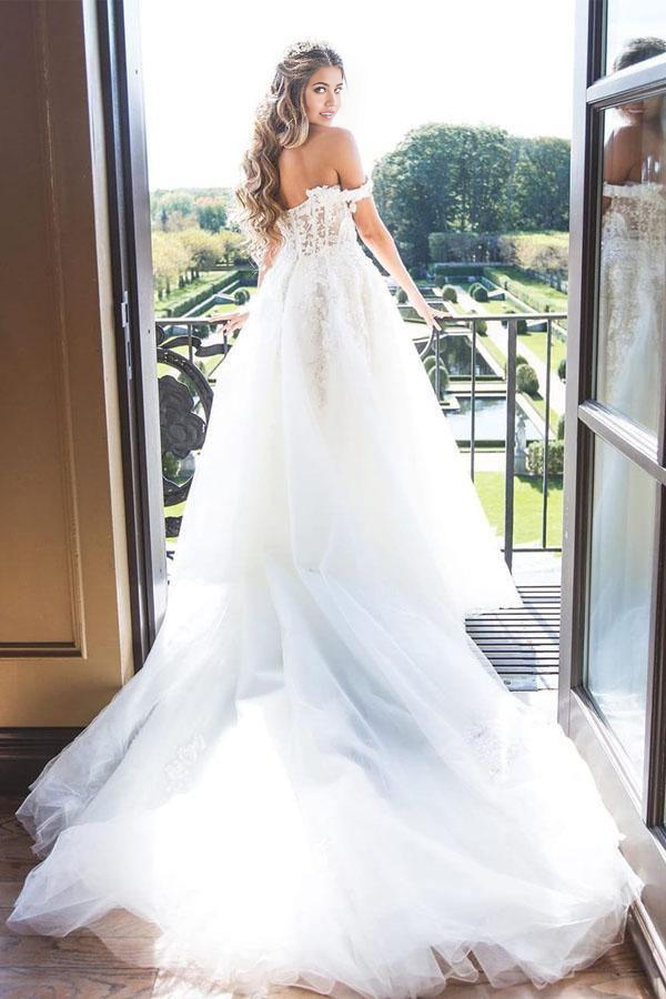 Romantic A-line off-shoulder bridal gown featuring delicate lace and flowing tulle.