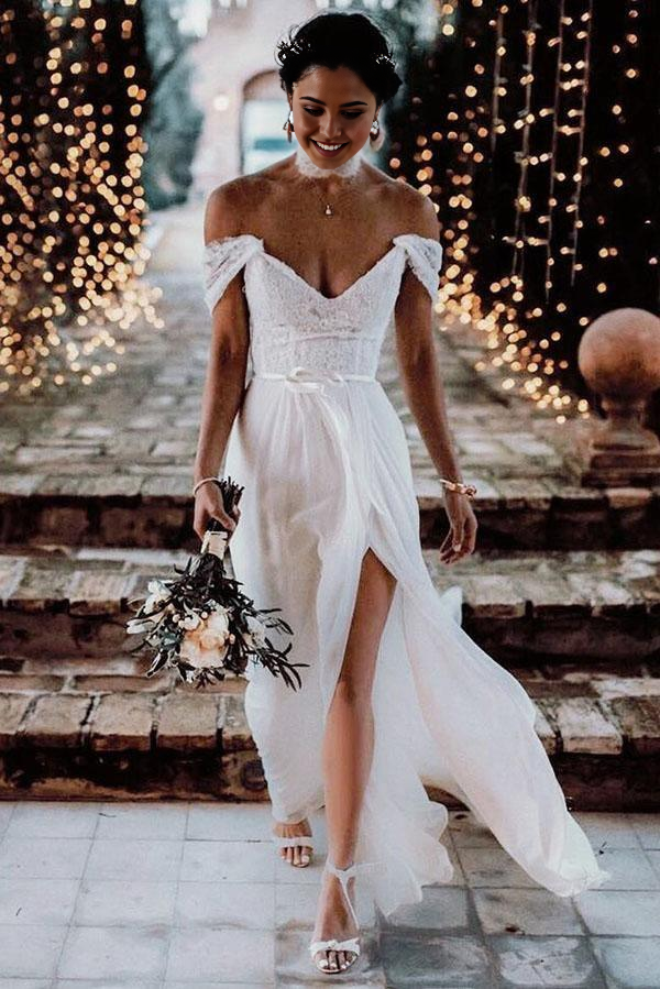 Elegant A-line ivory wedding dress with off-shoulder lace bodice and flowing chiffon skirt.