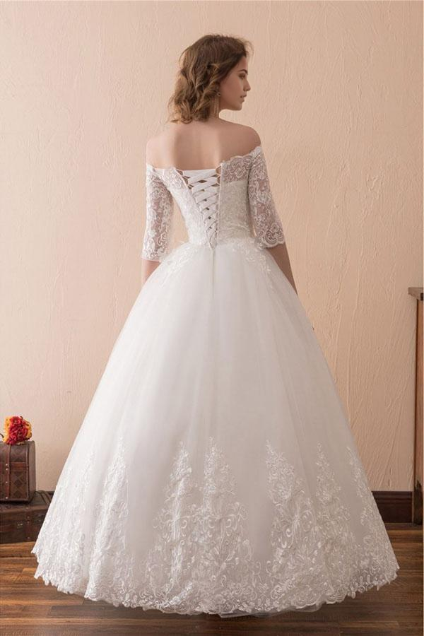Side view of the A-line off-shoulder lace ball gown wedding dress.