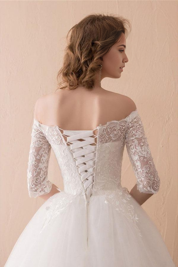 Close-up of delicate lace detail on the A-line off-shoulder wedding dress.