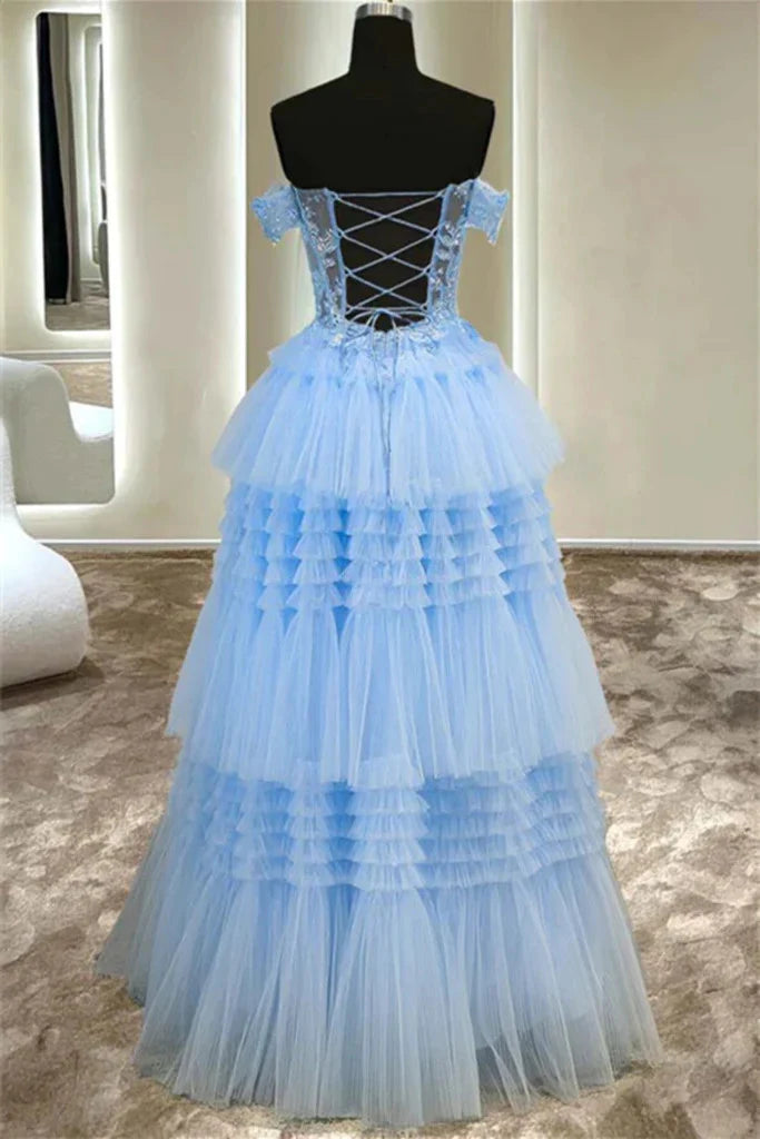Back view of a woman wearing an elegant blue A-line off-shoulder lace long prom dress.