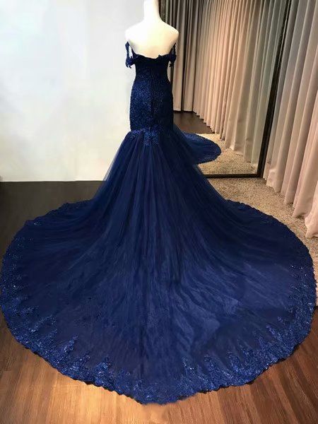 Full view of a vintage-style navy blue evening gown with lace bodice and tulle skirt.