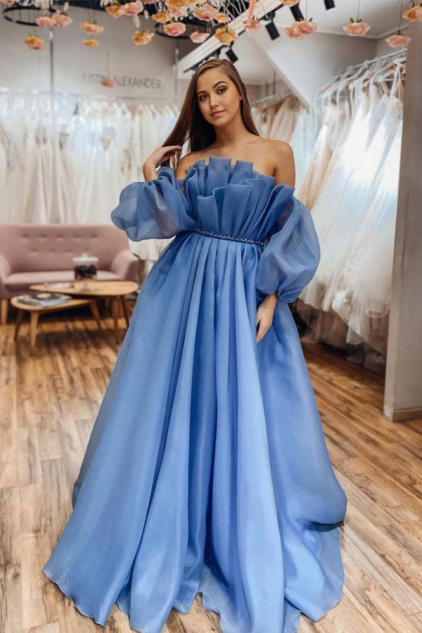 Back view of a blue A-line off-shoulder long sleeve prom dress.