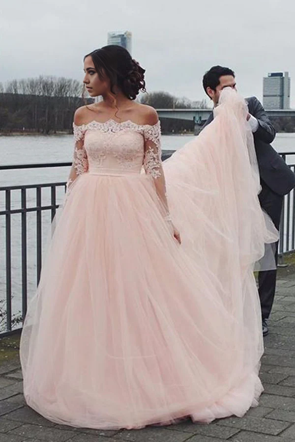 Back view of the blush pink A-line wedding gown, showcasing its flowing skirt.