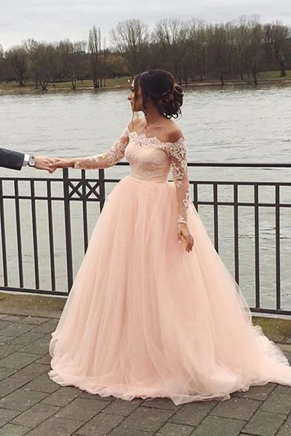 Close-up of the off-shoulder neckline and long sleeves on the blush pink bridal dress.