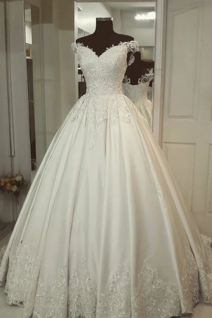Elegant off-shoulder princess wedding gown with intricate appliques.